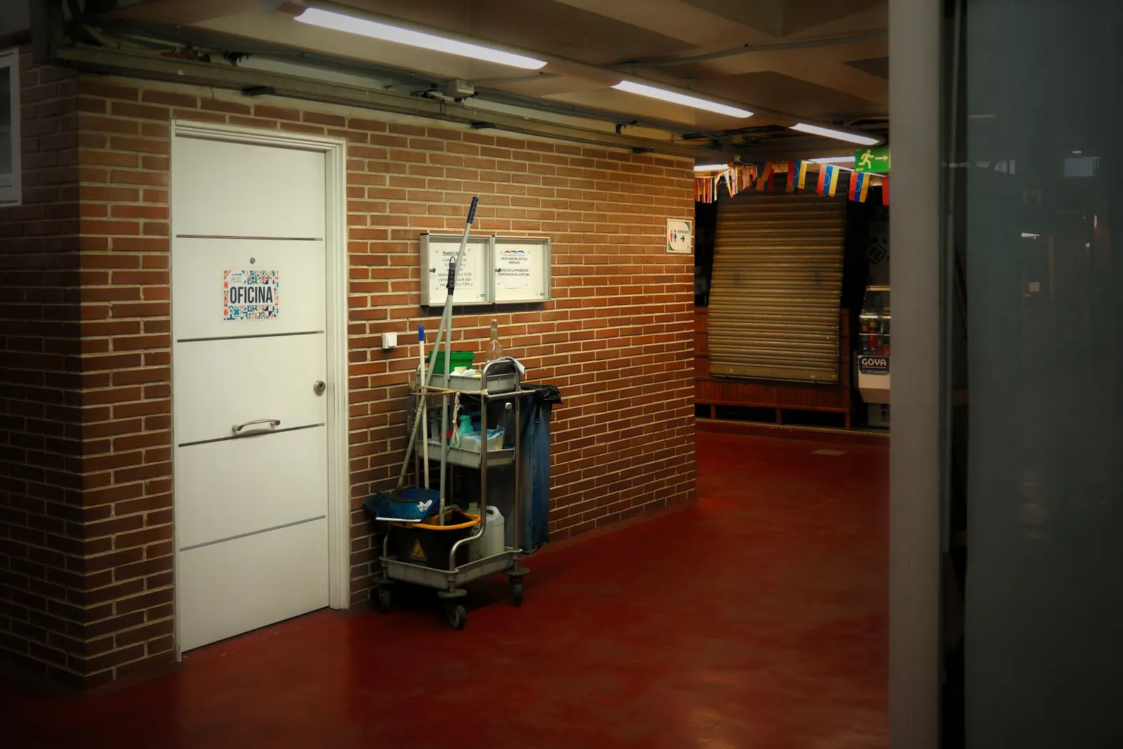 Janitorial cleaning cart and supplies in a commercial building hallway