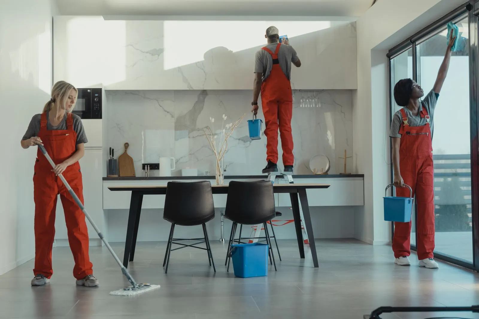 Cleaning crew mopping and wiping in a bright modern space