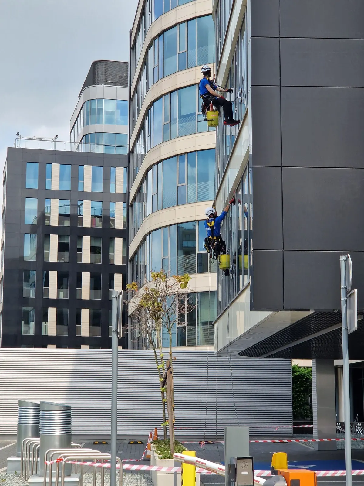 Window cleaners working on the exterior of an office building