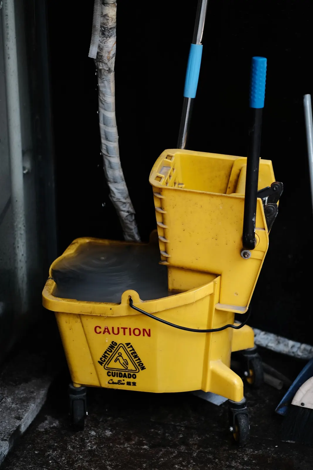 Mop bucket with wet floor caution sign